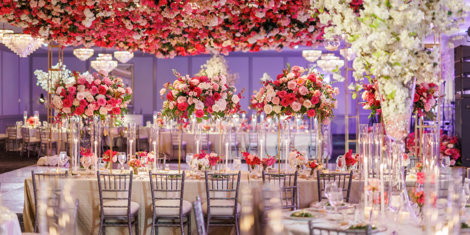 Elegant wedding reception with tall floral centerpieces